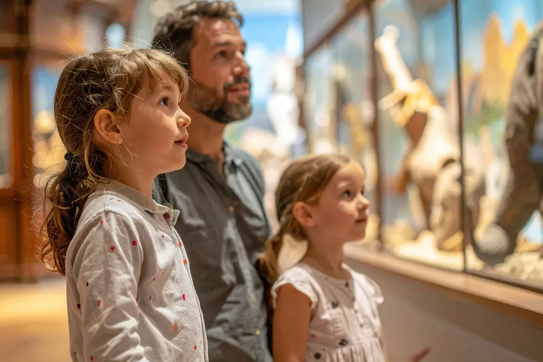 A father and two children looking into a museum display case