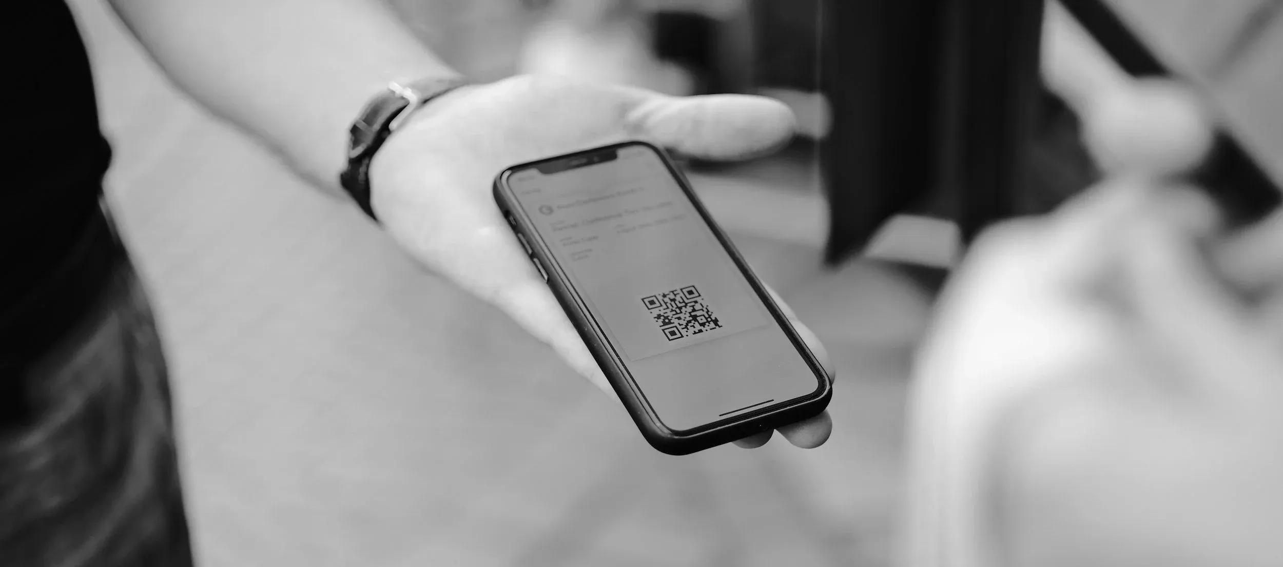 A visitor scanning a QR code on their phone at a park entrance